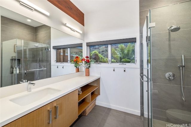 bathroom featuring vanity, an enclosed shower, toilet, and tile patterned flooring