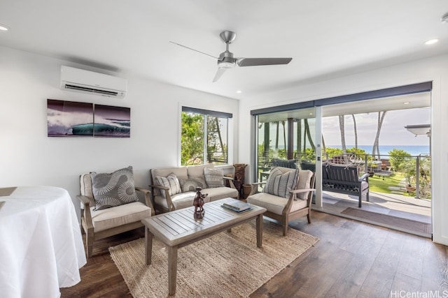 living room with a water view, ceiling fan, dark hardwood / wood-style flooring, and a wall unit AC