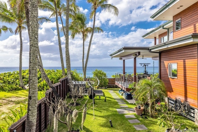 view of yard featuring a water view and ceiling fan