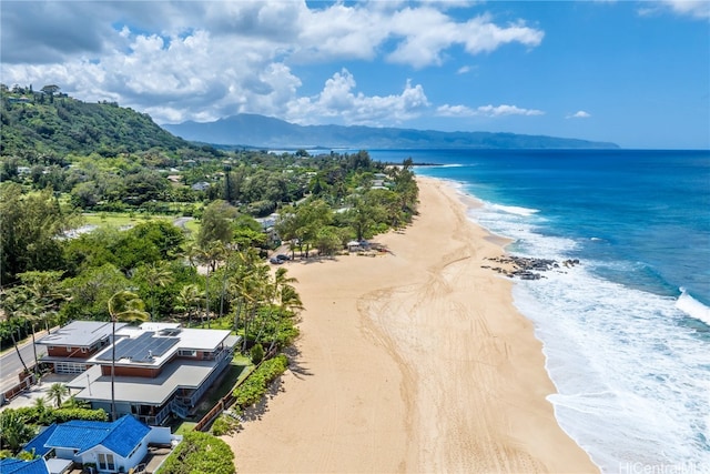 bird's eye view with a water view and a beach view