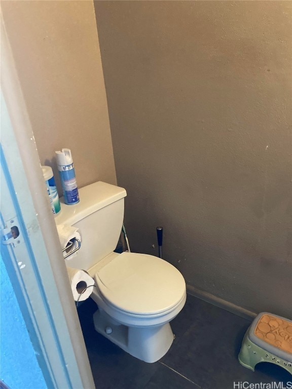 bathroom with toilet and tile patterned floors