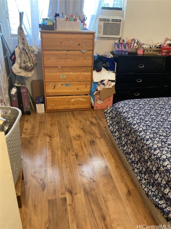 bedroom featuring hardwood / wood-style flooring and cooling unit