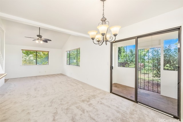 empty room with lofted ceiling, carpet floors, and ceiling fan with notable chandelier