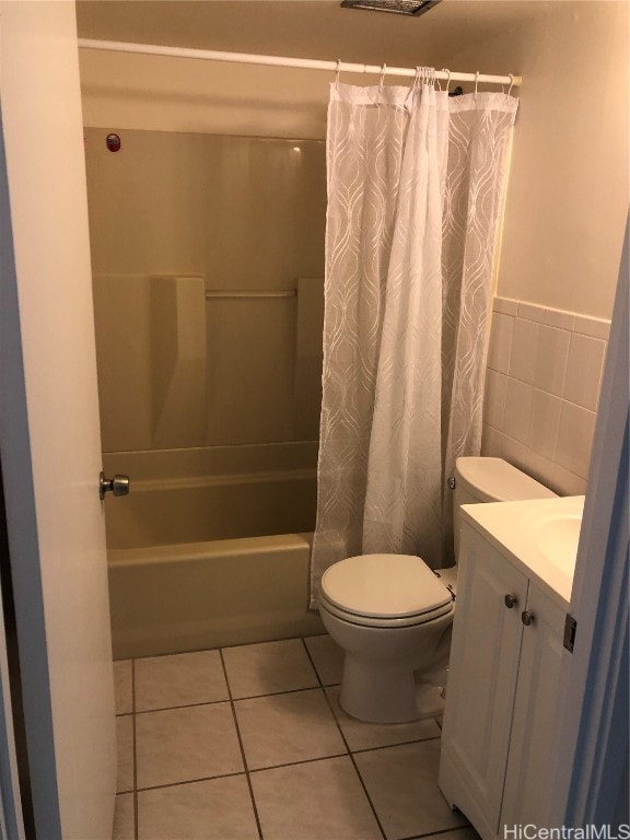 full bathroom featuring tile walls, toilet, vanity, shower / tub combo with curtain, and tile patterned flooring