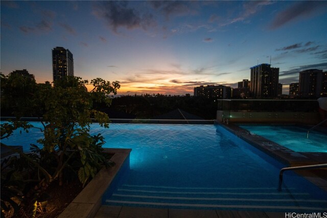 view of pool at dusk