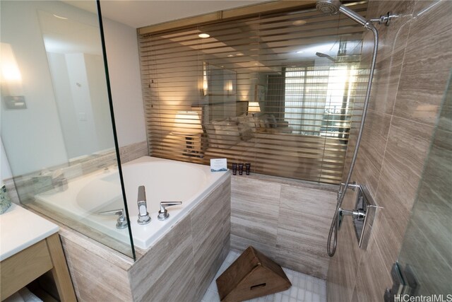 bathroom with vanity and independent shower and bath