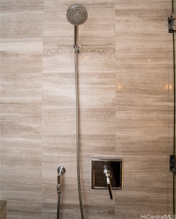 interior details featuring a tile shower