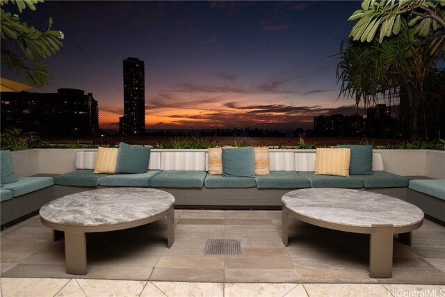 patio terrace at dusk featuring an outdoor living space