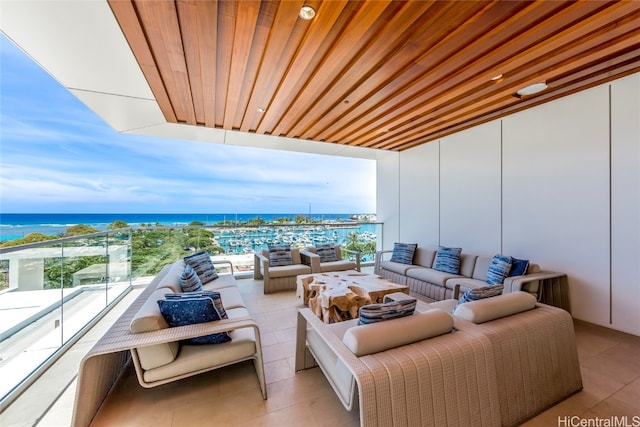 balcony with a water view and an outdoor hangout area