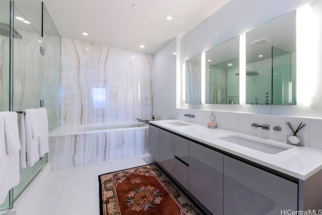 bathroom featuring vanity, shower with separate bathtub, and tile patterned flooring