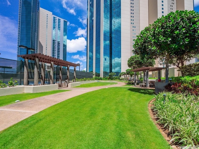 surrounding community with a yard and a pergola