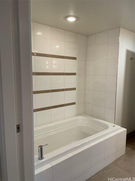 bathroom featuring tiled tub and tile patterned floors