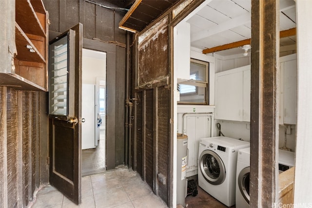 laundry room featuring cabinets, washing machine and dryer, and light tile patterned floors