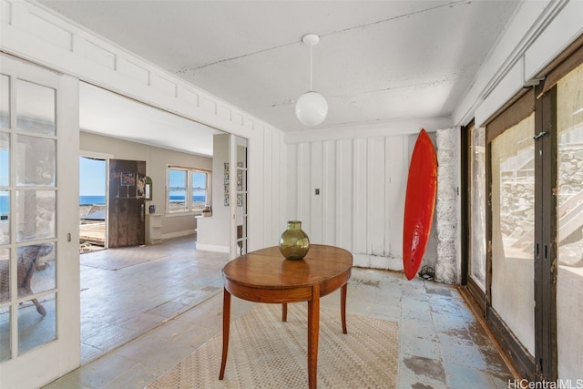 sunroom featuring a water view