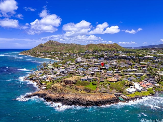 birds eye view of property with a water and mountain view