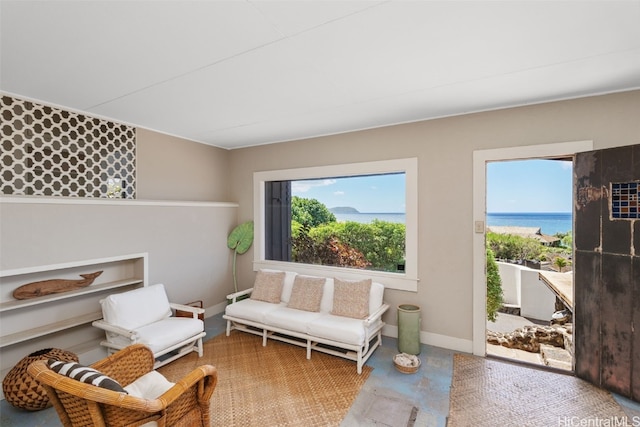 living area with a water view and a healthy amount of sunlight