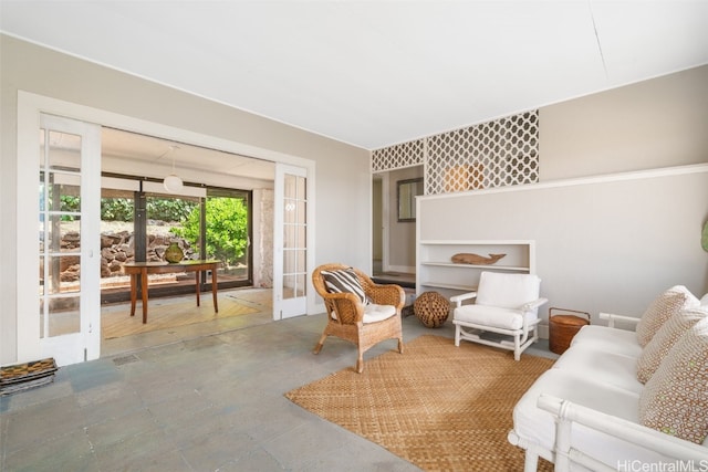 living room featuring french doors and concrete floors