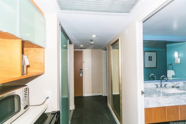 410 Atkinson Dr Unit 907, Honolulu, HI 96814 - corridor with recessed lighting, visible vents, dark tile patterned flooring, and a sink
