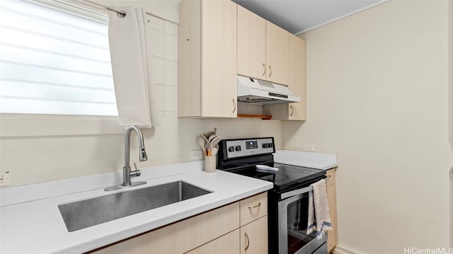 kitchen featuring stainless steel electric range, sink, and light brown cabinets