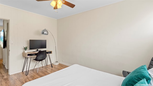 bedroom with light hardwood / wood-style floors and ceiling fan