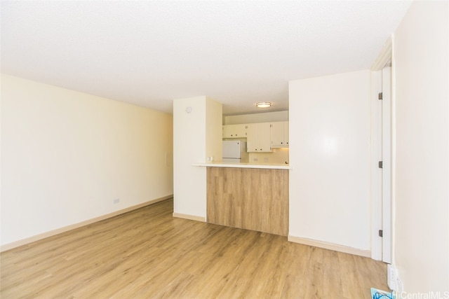 unfurnished living room featuring light hardwood / wood-style floors