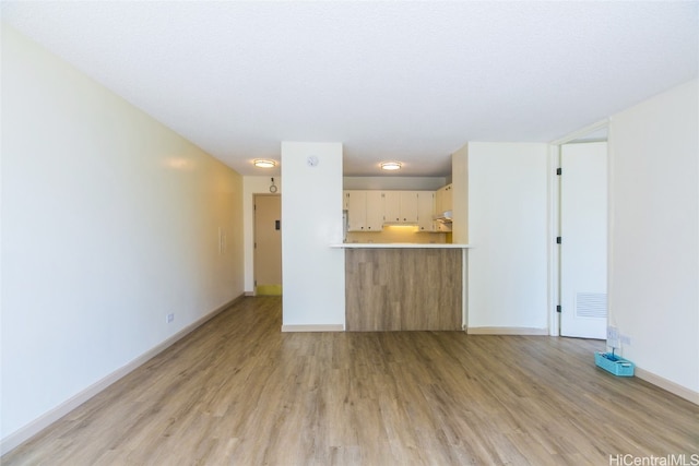 unfurnished living room featuring light hardwood / wood-style floors