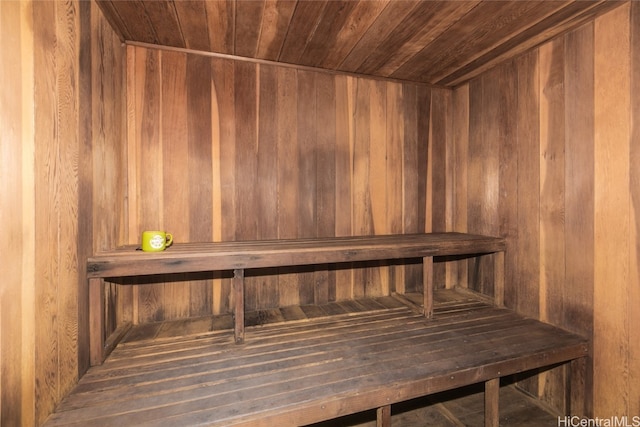 view of sauna with wooden walls and wood ceiling