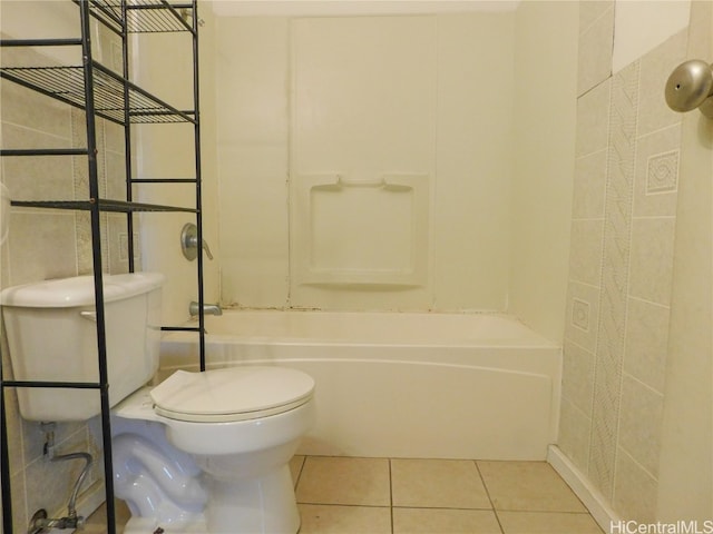 bathroom featuring toilet,  shower combination, and tile patterned floors