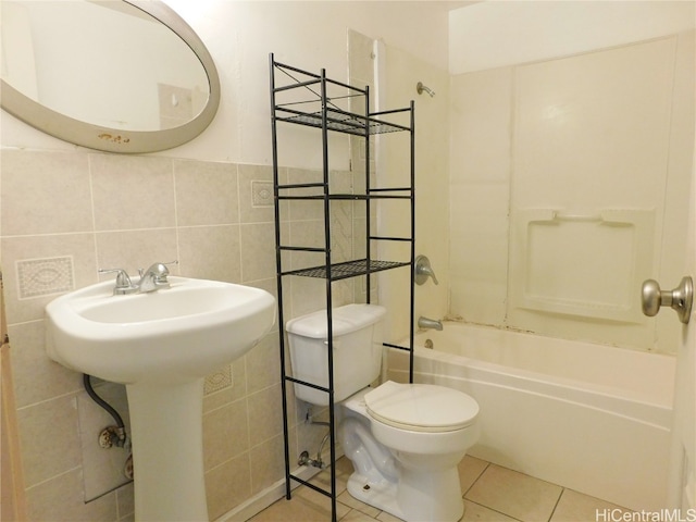 bathroom featuring toilet, shower / bath combination, tile walls, and tile patterned floors