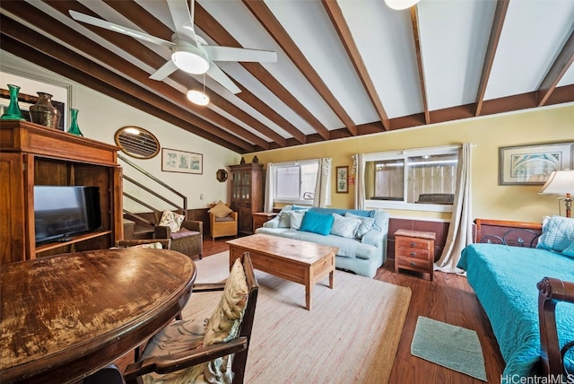 living room with ceiling fan, vaulted ceiling with beams, and dark hardwood / wood-style floors