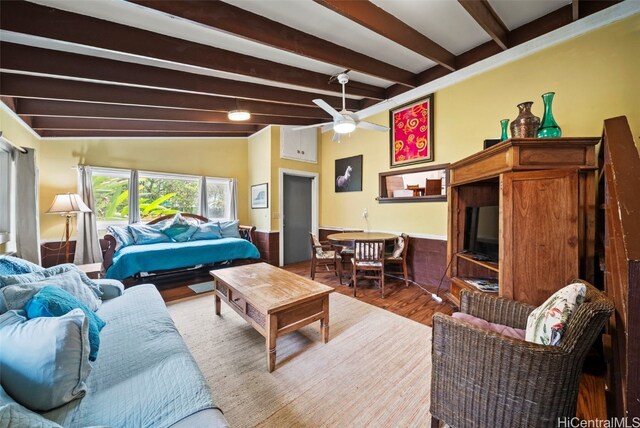 living room featuring lofted ceiling with beams, hardwood / wood-style flooring, and ceiling fan