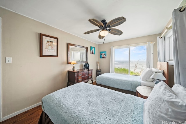 bedroom with ceiling fan and dark hardwood / wood-style floors