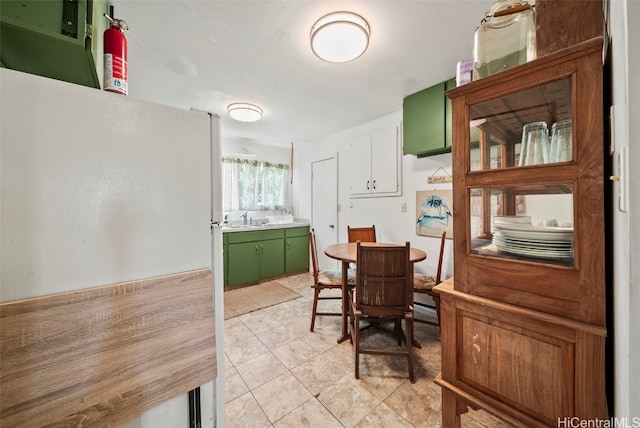 dining room with sink and light tile patterned floors