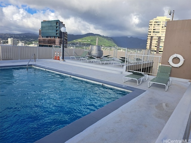 view of pool with a mountain view and a patio area