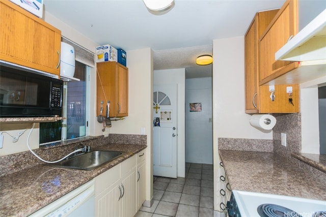 kitchen featuring sink, light tile patterned flooring, white appliances, and tasteful backsplash