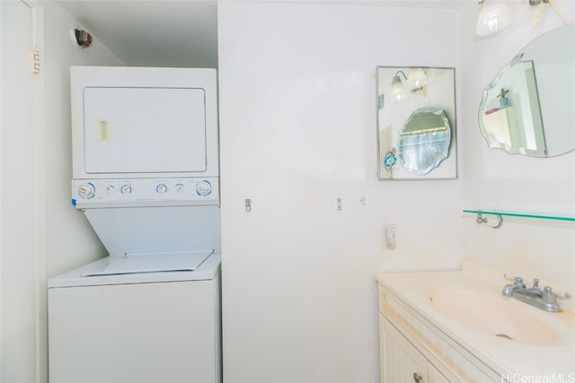 laundry room with stacked washer / drying machine and sink