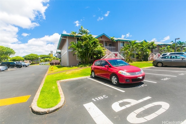 view of vehicle parking with a lawn