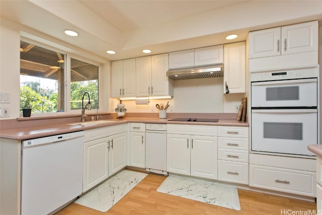 kitchen featuring white appliances, white cabinetry, and sink