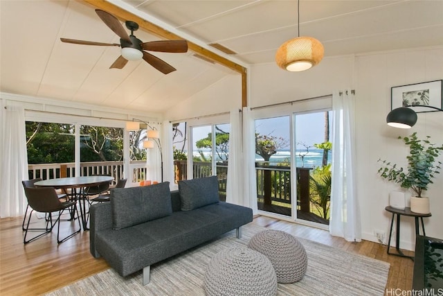 sunroom with ceiling fan and lofted ceiling with beams