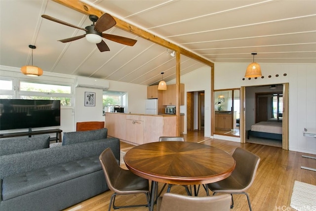 dining space featuring vaulted ceiling with beams, light hardwood / wood-style flooring, ceiling fan, and an AC wall unit