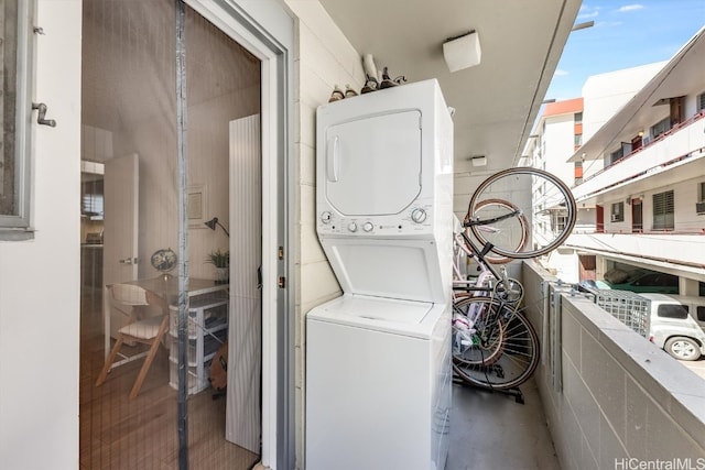 laundry area featuring stacked washer and dryer