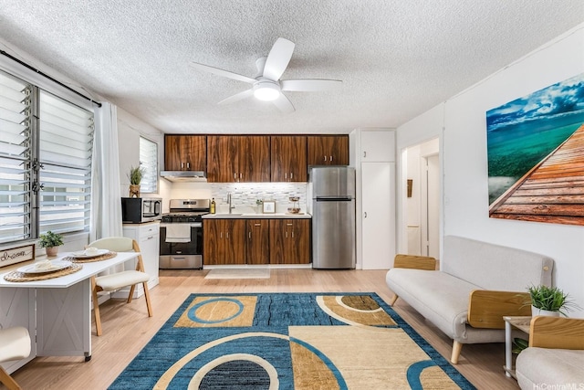 1145 Davenport St Unit 206, Honolulu, HI 96822 - living area featuring a ceiling fan, light wood-style floors, and a textured ceiling