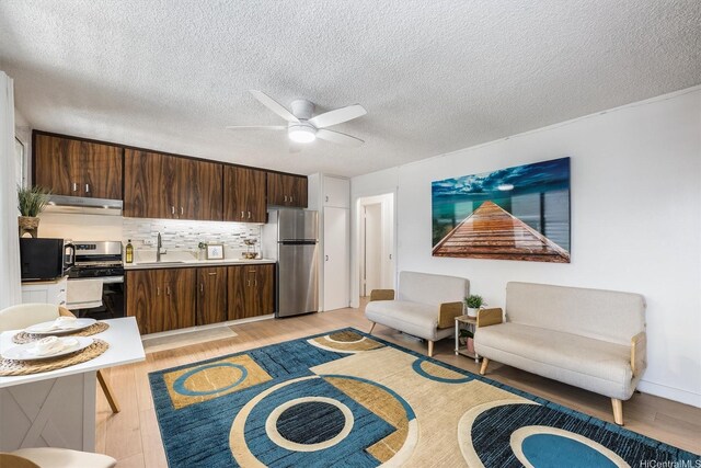 1145 Davenport St Unit 206, Honolulu, HI 96822 - living area featuring light wood-style flooring, a ceiling fan, and a textured ceiling