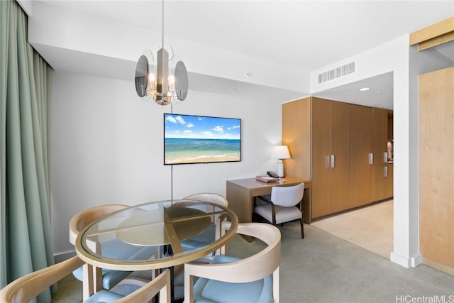 dining space featuring light colored carpet and a chandelier