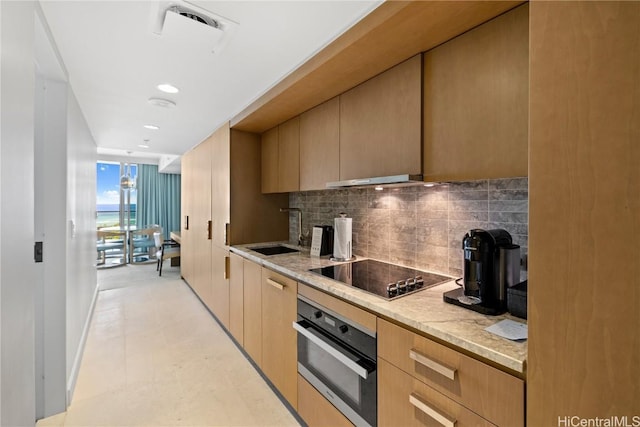 kitchen featuring decorative backsplash, stainless steel oven, black electric cooktop, sink, and light brown cabinets