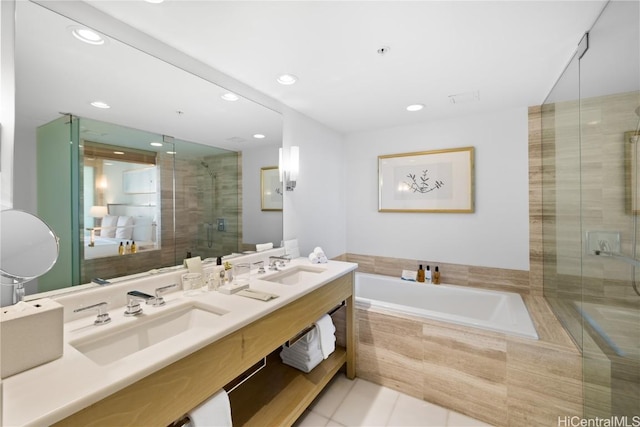 bathroom featuring tile patterned floors, vanity, and shower with separate bathtub