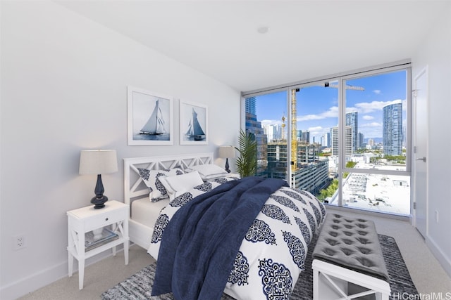 bedroom featuring access to exterior, carpet floors, and floor to ceiling windows