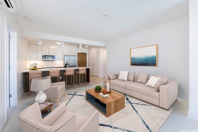 living room featuring baseboards and a wall mounted air conditioner