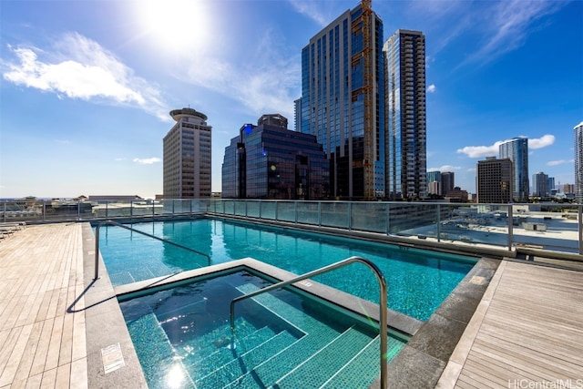 view of swimming pool with a community hot tub