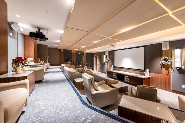 carpeted cinema room with wood walls